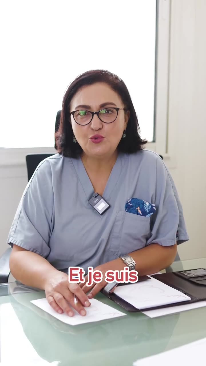Professionnelle de santé en blouse assise à un bureau, s'adressant à la caméra avec sous-titres incrustés.